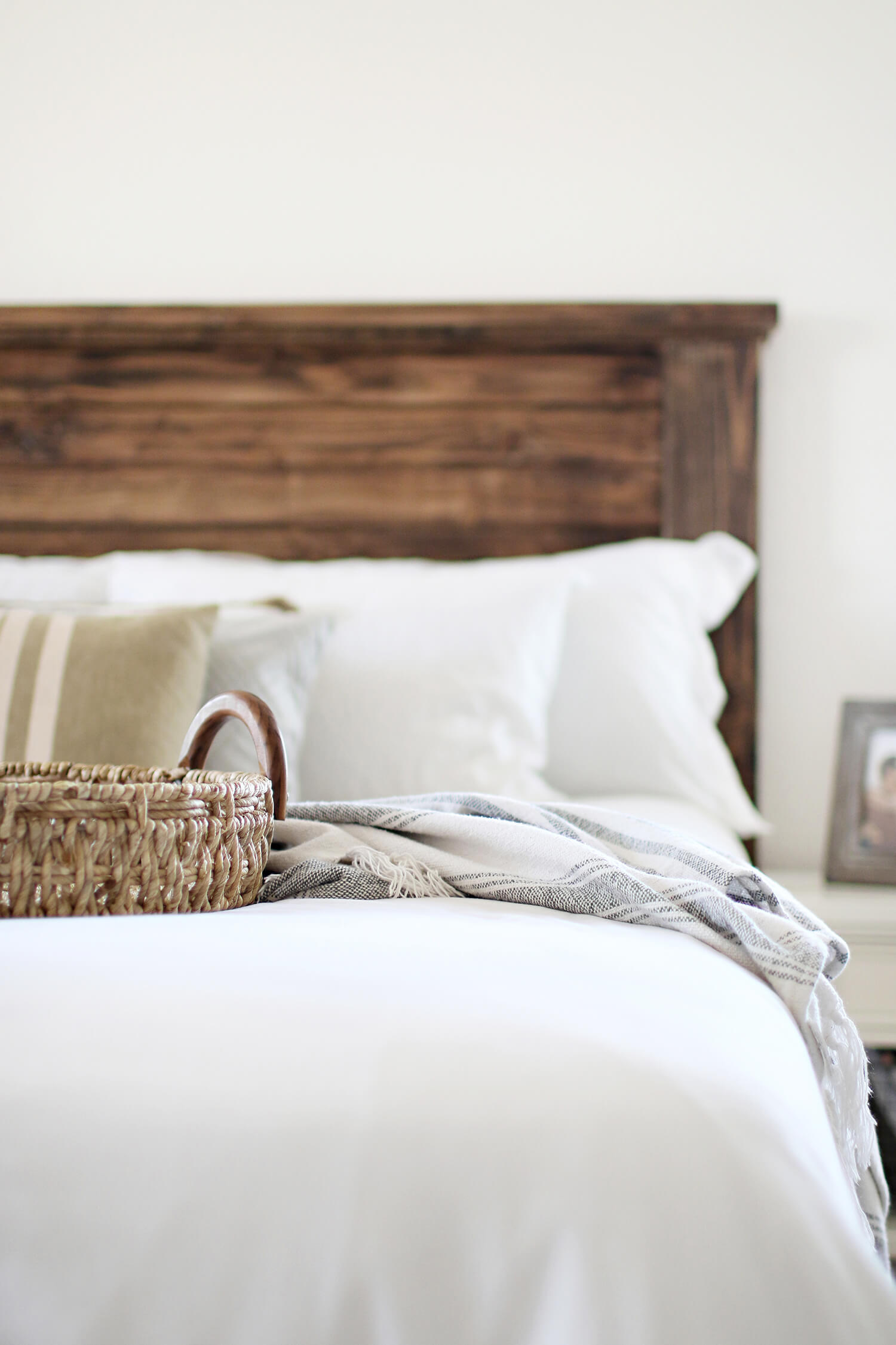 Sharing a DIY farmhouse headboard project including plans and supply list for you! We built this for a California King size bed, but you could easily customize the measurements for your own DIY headboard. Catch it now over on KaraLayne.com!