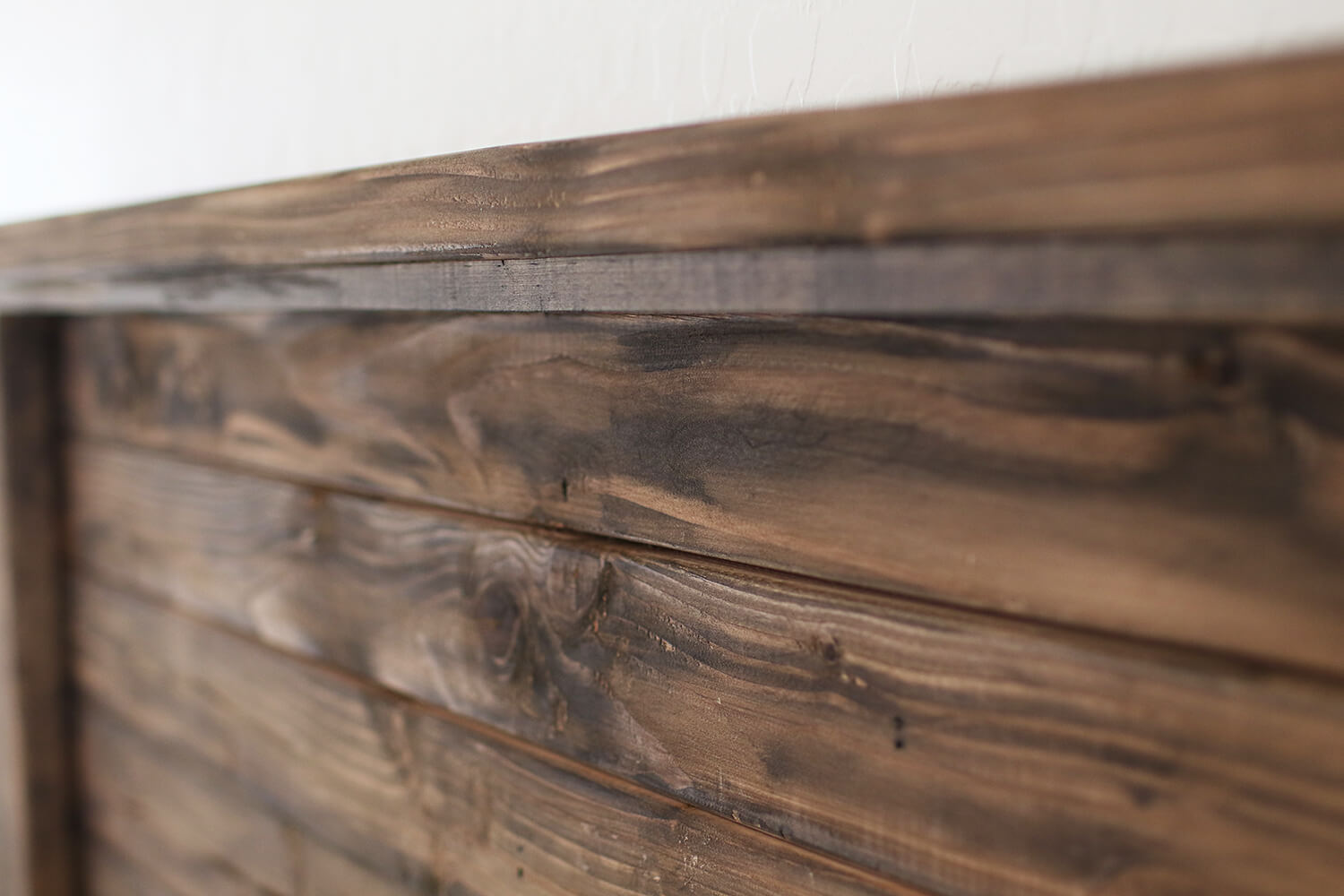 Sharing a DIY farmhouse headboard project including plans and supply list for you! We built this for a California King size bed, but you could easily customize the measurements for your own DIY headboard. Catch it now over on KaraLayne.com!