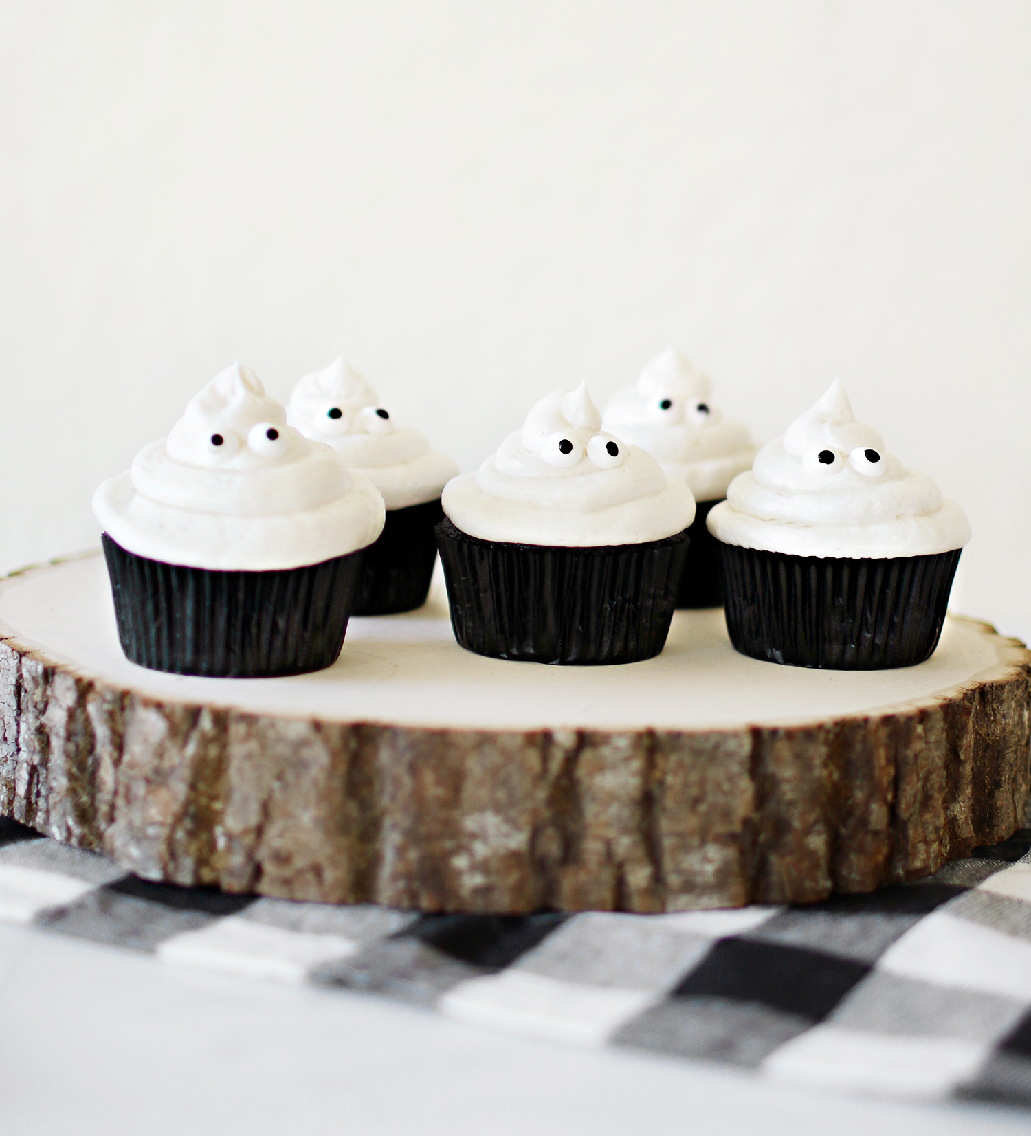 Black velvet and vanilla butter cream ghost cupcakes that our family loves to make for the Halloween festivities. Simple recipes and easy decorating make these cupcakes a hit for anyone who gets to make them. They are also delicious for all who get to enjoy them. Catch the entire recipe for our Ghost in the Graveyard cupcakes over at Haus of Layne! #HalloweenFood #HalloweenRecipe #HalloweenFoodIdeas #HalloweenTreats #Cupcakes #CupcakeRecipe #ButtercreamFrosting #BlackVelvetCake