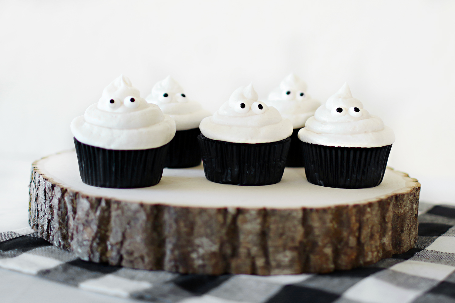 Black velvet and vanilla butter cream ghost cupcakes that our family loves to make for the Halloween festivities. Simple recipes and easy decorating make these cupcakes a hit for anyone who gets to make them. They are also delicious for all who get to enjoy them. Catch the entire recipe for our Ghost in the Graveyard cupcakes over at Haus of Layne! #HalloweenFood #HalloweenRecipe #HalloweenFoodIdeas #HalloweenTreats #Cupcakes #CupcakeRecipe #ButtercreamFrosting #BlackVelvetCake