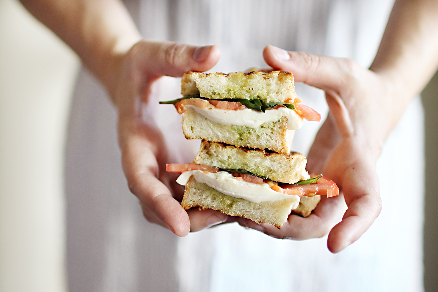 A fresh and easy recipe for a delicious basil, tomato and mozzarella sandwich. The perfect option for a light summer meal! Get the recipe now on Haus of Layne! #EasyMealIdeas #SandwichIdeas #SummerRecipeIdeas #Basil #Mozzarella #Tomato #Pesto #Sandwich