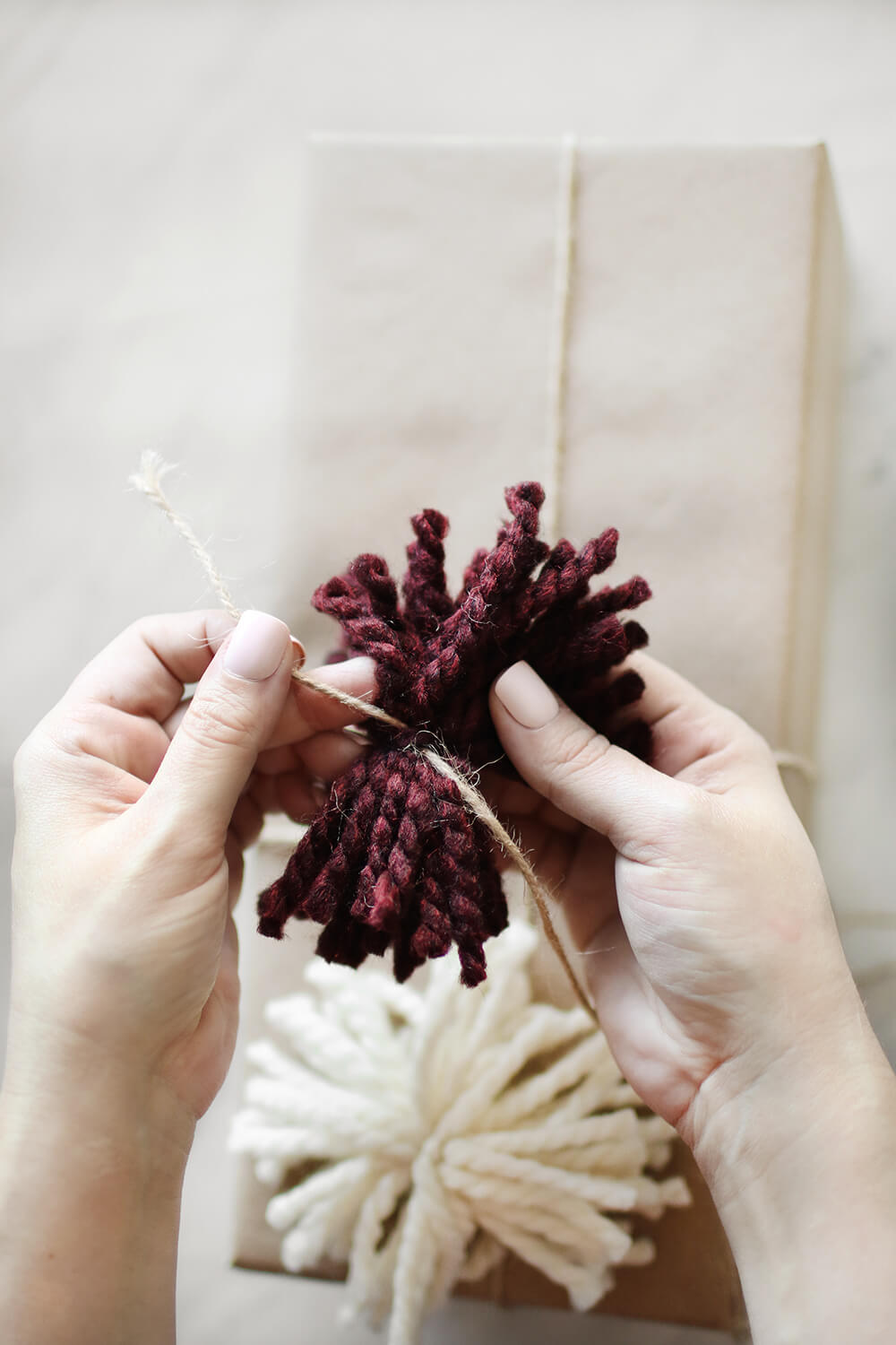 I am sharing how to DIY yarn pom poms to dress up your gift giving! I love the added texture and the layer it brings and they are super simple to create. Catch it over on KaraLayne.com!