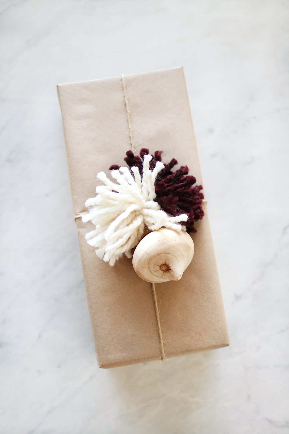 I am sharing how to DIY yarn pom poms to dress up your gift giving! I love the added texture and the layer it brings and they are super simple to create. Catch it over on KaraLayne.com!